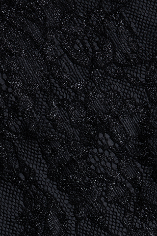 Close-up of the Henriette Cropped Lace Tops intricate black lace fabric, showcasing a delicate floral pattern with a combination of sheer and opaque textures. The material offers an elegant appearance with subtle shine in select areas, making it perfect for creating a sophisticated cropped top with refined details.