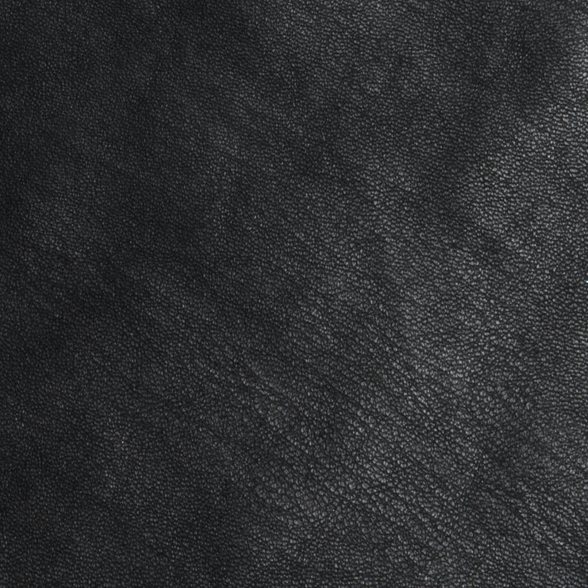 Close-up of the Tullia Scoopneck Tank in textured black vegan leather, showing subtle grain patterns and natural creases. The image highlights the quality material of this stretch leather tank, capturing its sophisticated look.