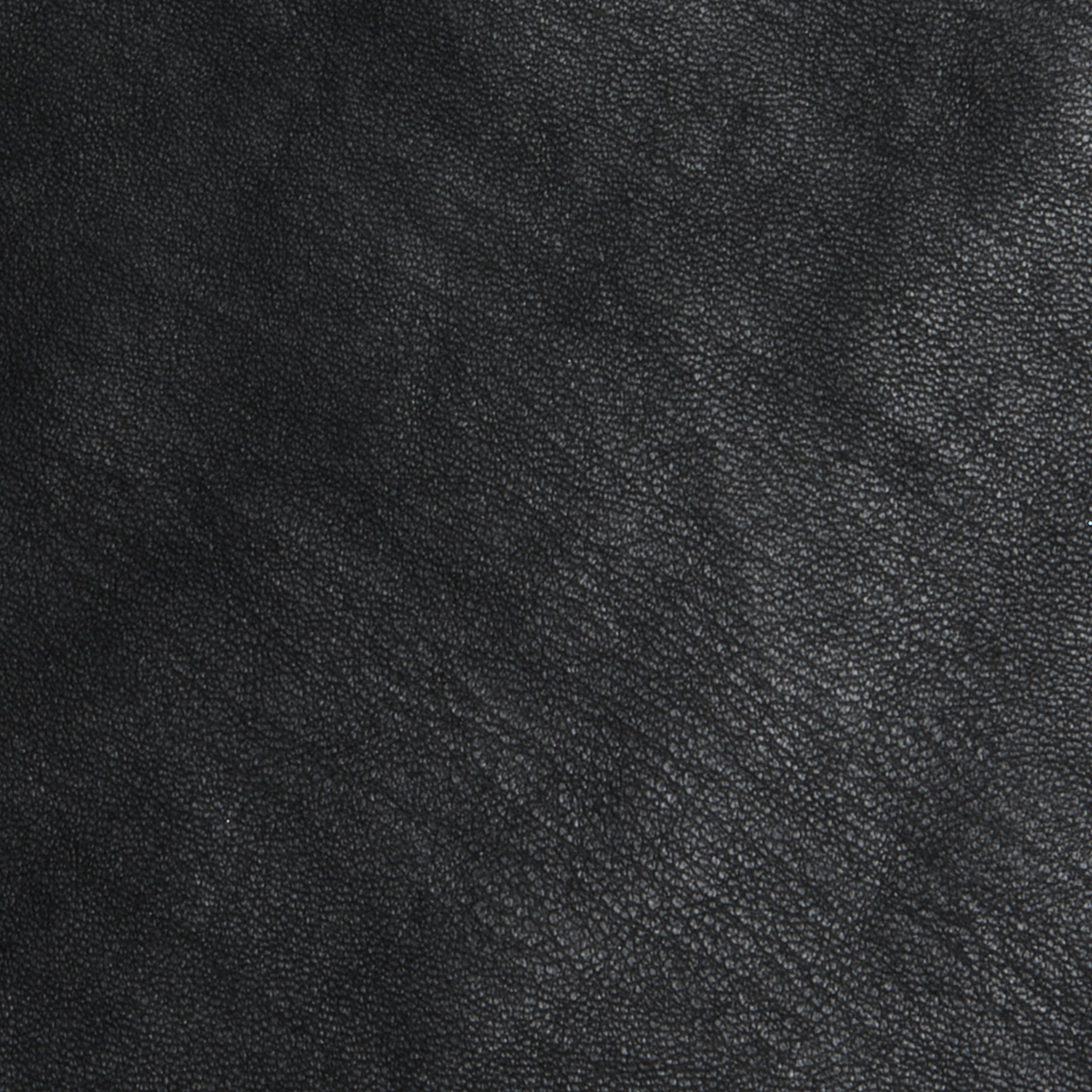 Close-up of the Tullia Scoopneck Tank in textured black vegan leather, showing subtle grain patterns and natural creases. The image highlights the quality material of this stretch leather tank, capturing its sophisticated look.