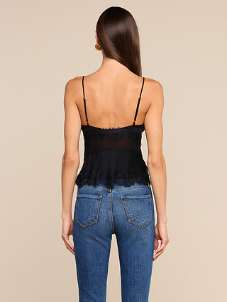 A woman with long brown hair, wearing the Elka Satin Lace Camisole in black and blue jeans, is standing with her back to the camera against a plain beige background.