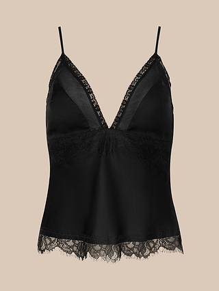 The Elka Satin Lace Camisole, featuring thin straps, a deep V-neckline, and delicate lace trim along the neckline and hem, is elegantly displayed against a plain beige background.