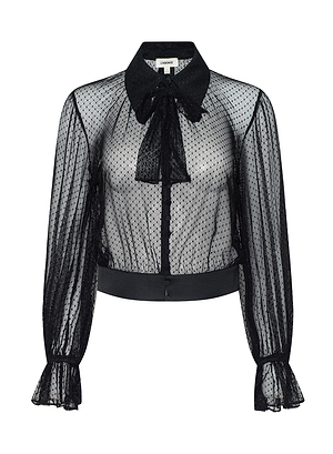 The Eugenia Blouse features a sheer black polka dot design, long sleeves, large collar, front tie bow, button-down front, ruffled cuffs, and solid black waistband—ideal for embracing modern Fall 2026 Fashion Week style.