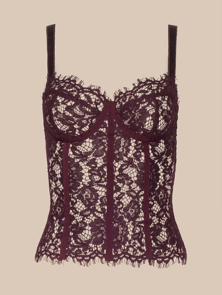 The Jenny Lace Bustier features underwire cups, delicate floral lace detailing, sheer fabric, and adjustable straps. Displayed on a beige background, this elegant bustier combines supportive structure with romantic design for a stunning look.