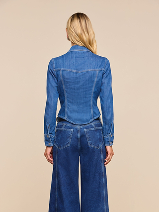 Wearing the Louis Fitted Shirt, a person with long blonde hair, seen from behind against a beige background, exudes a subtle sense of equestrian sophistication.