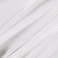 Close-up of the Soleia Lace Camisole’s white, slightly shiny silk charmeuse fabric featuring soft folds and subtle diagonal lines for a smooth and elegant texture.