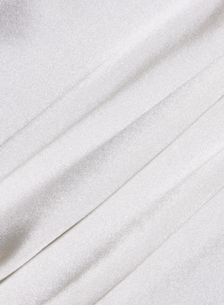 Close-up of smooth, white fabric with soft folds and gentle shadows, showcasing a silky texture and a subtle sheen—reminiscent of the luxurious Soleia Lace Camisole.