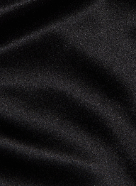 A close-up of the Evadne Silk Lace Camisole’s black silk fabric, featuring a soft, velvety texture with subtle highlights and gentle folds, finished with a slight sheen reminiscent of charmeuse.
