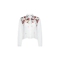 The Philomena Blouse features a white, long-sleeve button-down design with a collared neckline. A floral pattern of pink and purple roses with green leaves accents the top front section and shoulders. Crafted from semi-sheer Ramie, this blouse offers an airy, elegant finish.