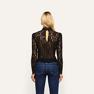 Back view of an Amarenthe Lace Blouse, a long-sleeved corded lace mockneck top featuring a teardrop cutout, worn with blue jeans.