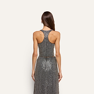 Back view of a person wearing a Nixe Embellished Vest and matching skirt, both covered in shimmering sequins and crystals.
