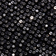 Close-up of the Nixe Embellished Vest, a black cropped vest densely covered in shimmering, round silver sequins.