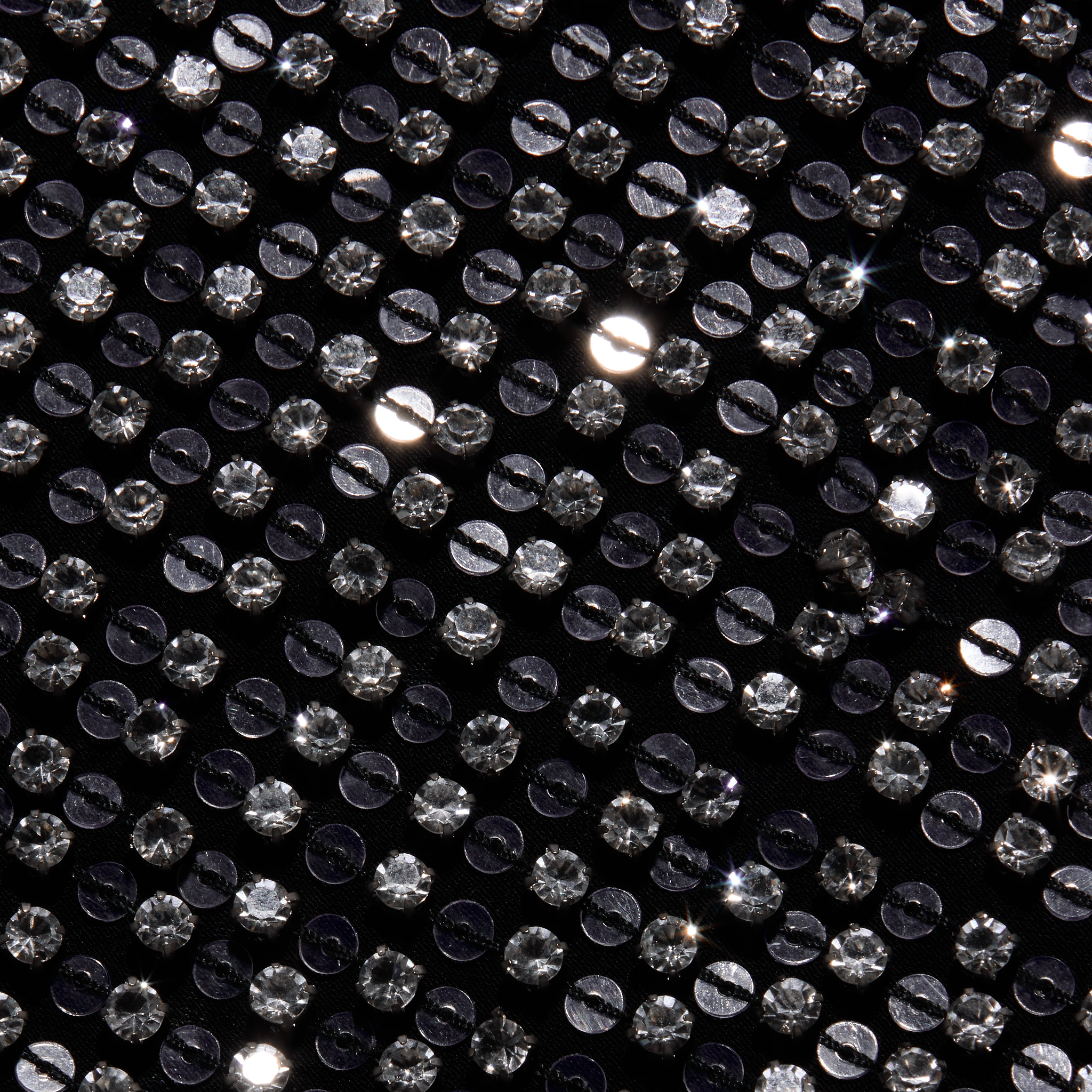 Close-up of the Nixe Embellished Vest, a black cropped vest densely covered in shimmering, round silver sequins.