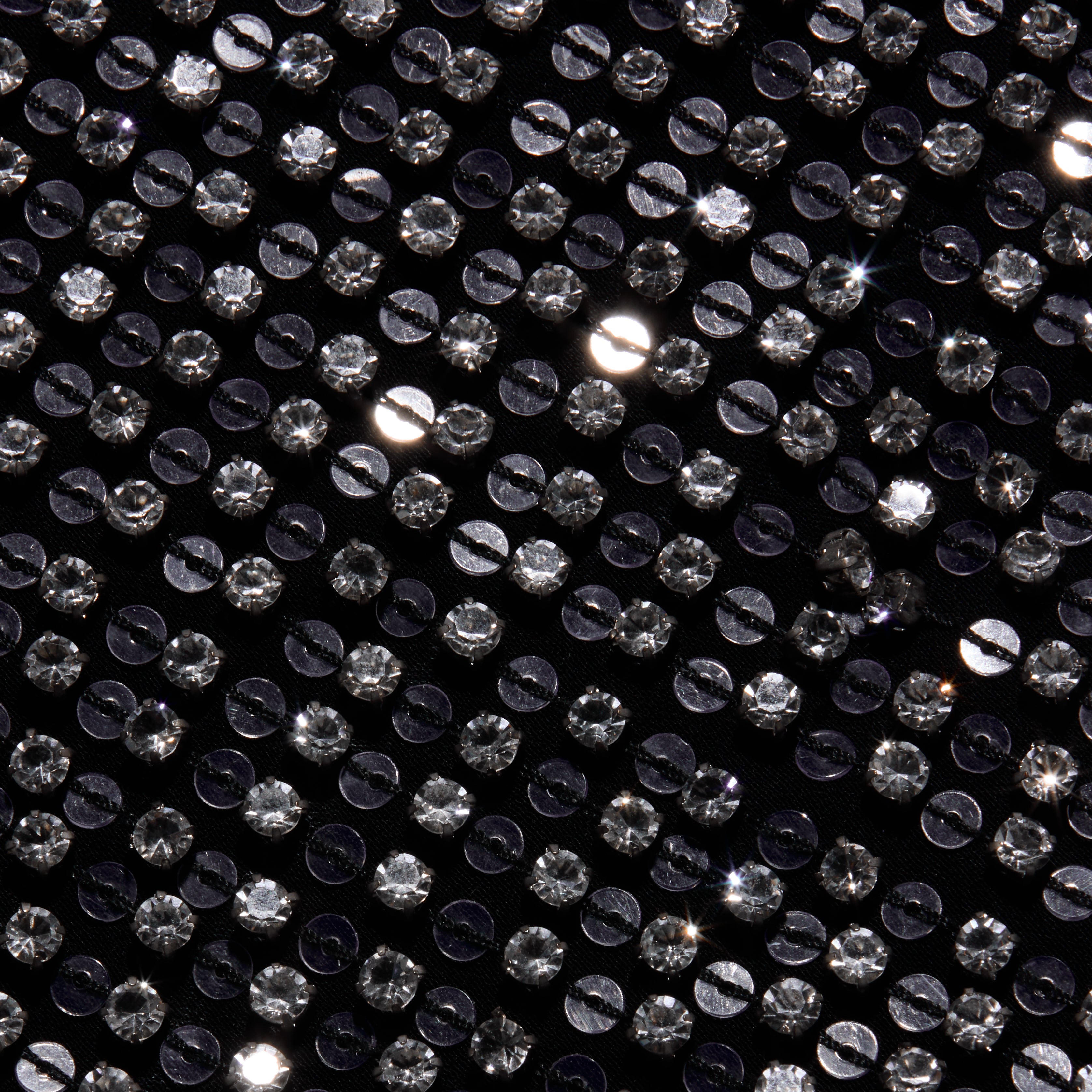 Close-up of the Nixe Embellished Vest, a black cropped vest densely covered in shimmering, round silver sequins.
