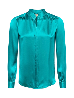 The Bianca Blouse is a teal, long-sleeved silk top with a slight sheen, collarless neckline, concealed button placket, subtle gathers at the shoulders and cuffs, and a relaxed silhouette for effortless style.