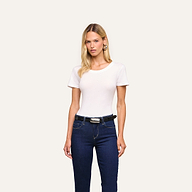 A woman faces forward, wearing the Cory Cotton Scoopneck Tee, dark blue jeans, and a black belt against a plain light background.