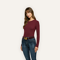 A person wearing a slim-fit, long-sleeved burgundy Tess Long Sleeve Tee tucked into dark wash jeans with a belt.