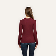 Back view of a person wearing a slim fit, long-sleeved burgundy Tess Long Sleeve Tee and blue jeans.