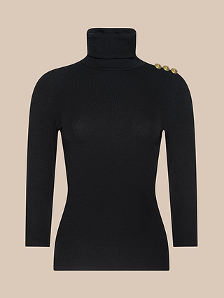 The Aja Turtleneck, crafted from soft modal and featuring three elegant gold buttons adorning the left shoulder, is displayed on a plain beige background.