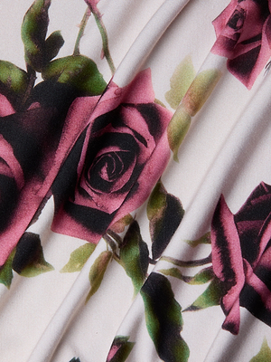 Close-up of stretch jersey knit with dark pink and black roses plus green leaves on a light background, with folds—ideal for crafting the Ressi Fitted Tee or any bestselling slim-cut top.
