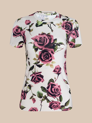 The Ressi Fitted Tee is a bestselling, slim-cut white t-shirt with large, realistic pink and deep red roses plus green leaves on a beige background for a modern look.
