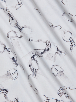 Close-up of white stretch jersey on the Ressi Fitted Tee, featuring a delicate print of overlapping black-and-gray chains and buckles for a soft, textured look with gentle folds—ideal for bestselling or slim cut designs.