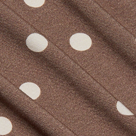 Close-up of the Ressi Fitted Tee in brown stretch jersey knit fabric featuring white, evenly spaced polka dots and subtle diagonal folds that highlight the fabric’s texture.
