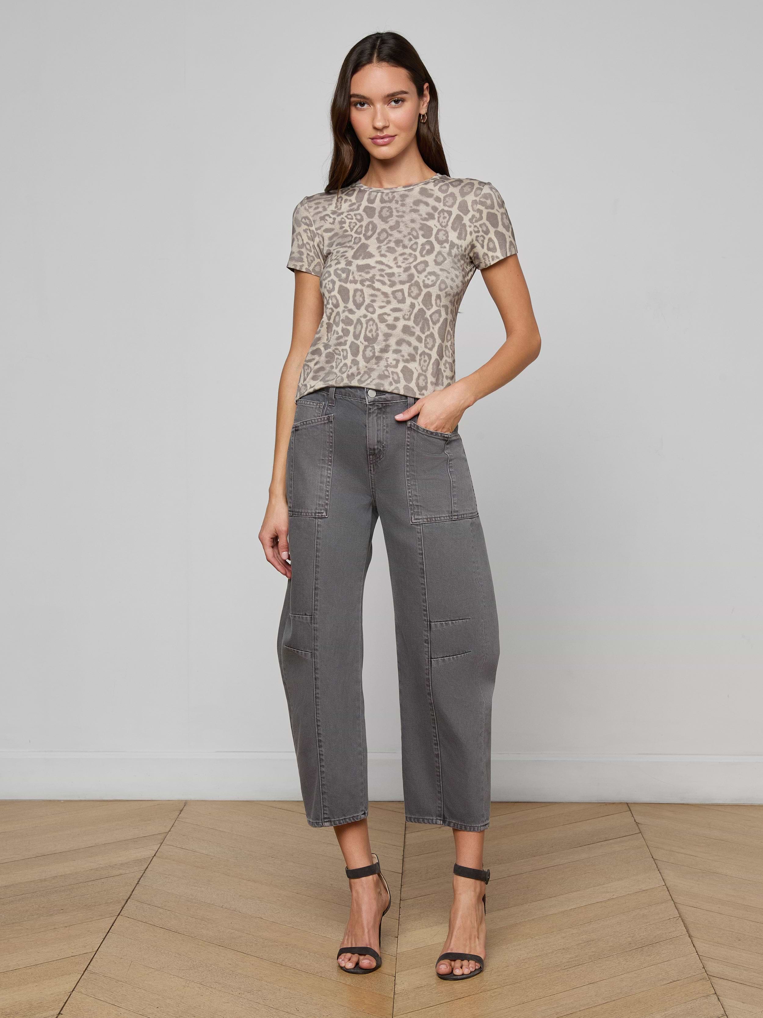 Woman wearing the Ressi Fitted Tee in gray leopard print, paired with gray cropped pants and black high-heeled sandals, standing against a plain white background.