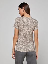 A woman stands with her back to the camera, wearing the bestselling Ressi Fitted Tee in gray leopard print and gray pants, against a plain light background.