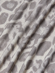 A close-up of the Ressi Fitted Tee showcases its stretch jersey knit fabric in a gray leopard print pattern, featuring soft folds and a slightly textured surface.