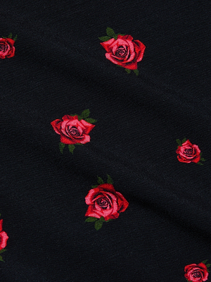 A black stretch jersey knit with red rose print and green leaves, perfect for sewing a charming Ressi Fitted Tee.