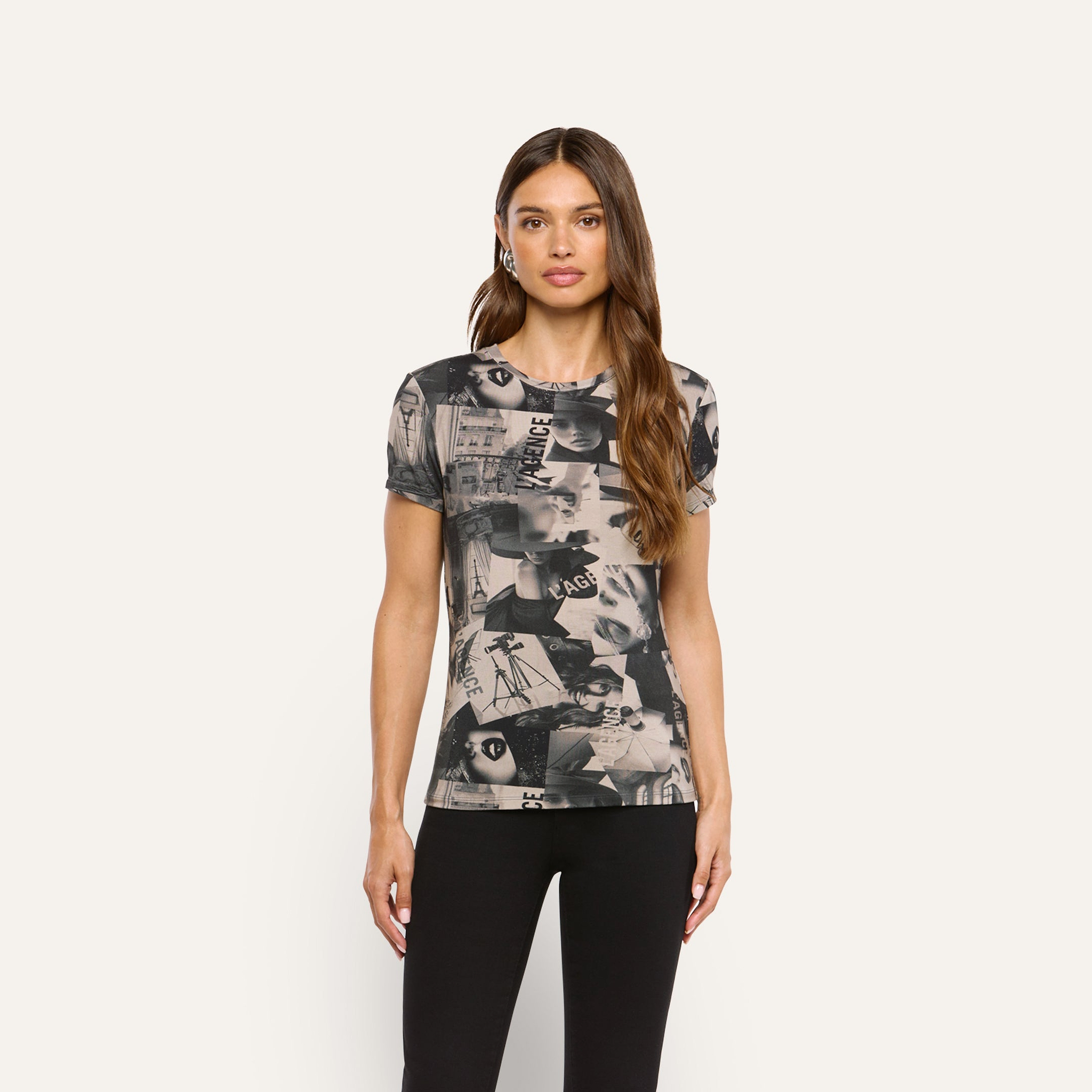 A woman wears a soft, short-sleeve Ressi Fitted Tee featuring a magazine collage print.
