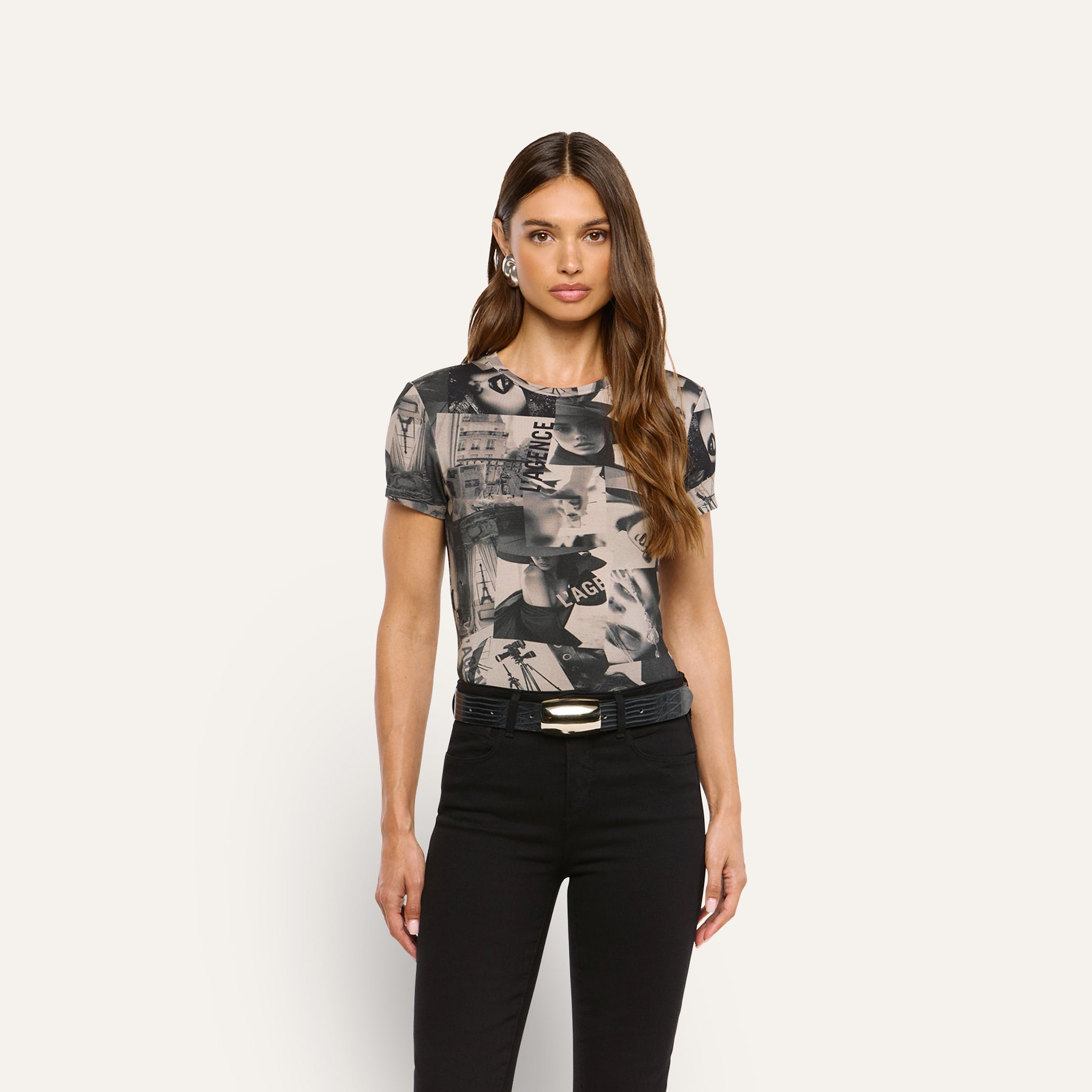 Woman wearing a Ressi Fitted Tee featuring a magazine collage print with black jeans.