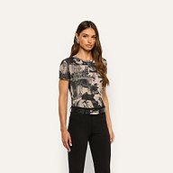 Model wearing a Ressi Fitted Tee featuring a magazine collage print, tucked into black pants with a black leather belt.