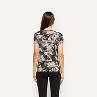 Back view of a person wearing a Ressi Fitted Tee, a soft jersey short-sleeve crewneck with an all-over black and white magazine collage print.