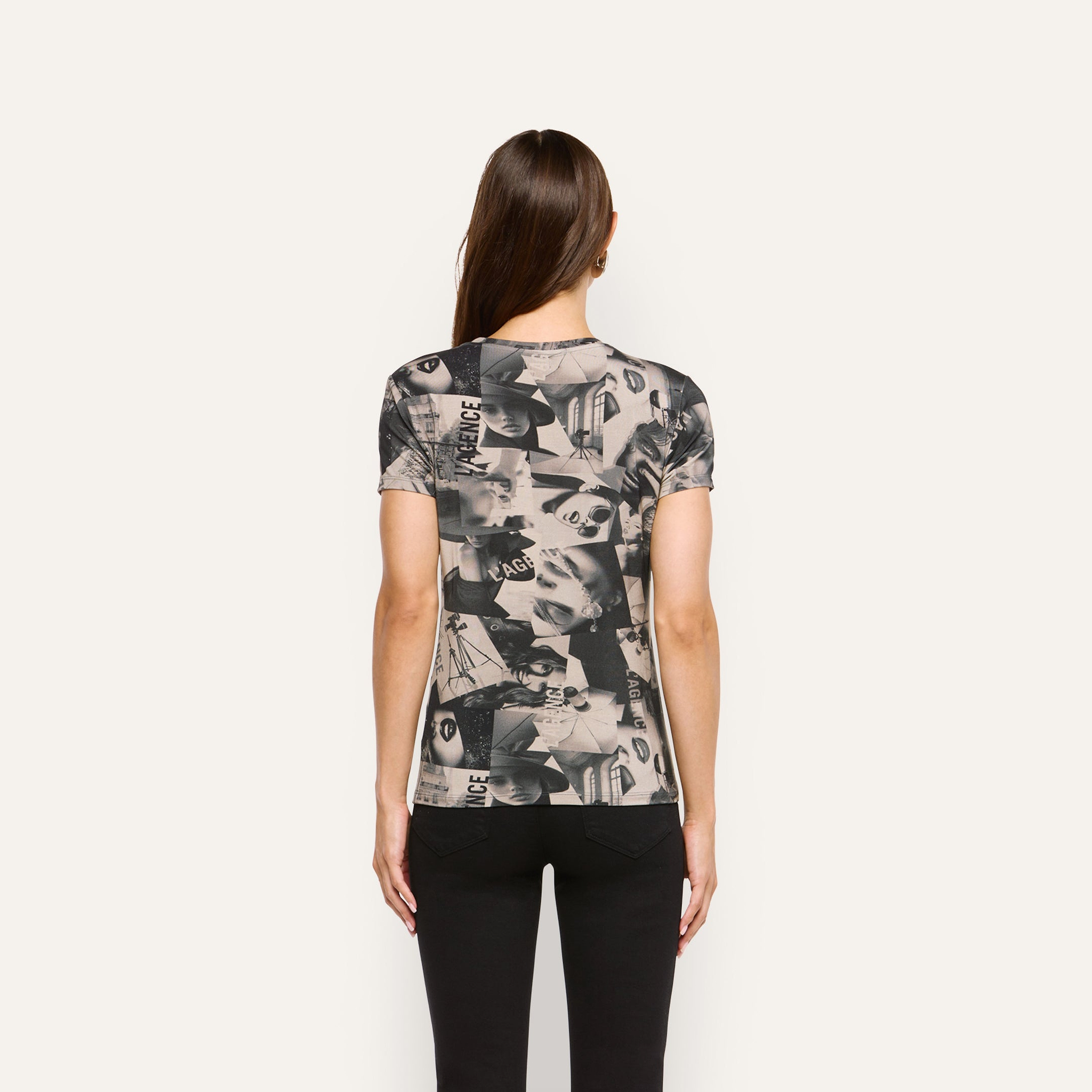 Back view of a person wearing a Ressi Fitted Tee, a soft jersey short-sleeve crewneck with an all-over black and white magazine collage print.
