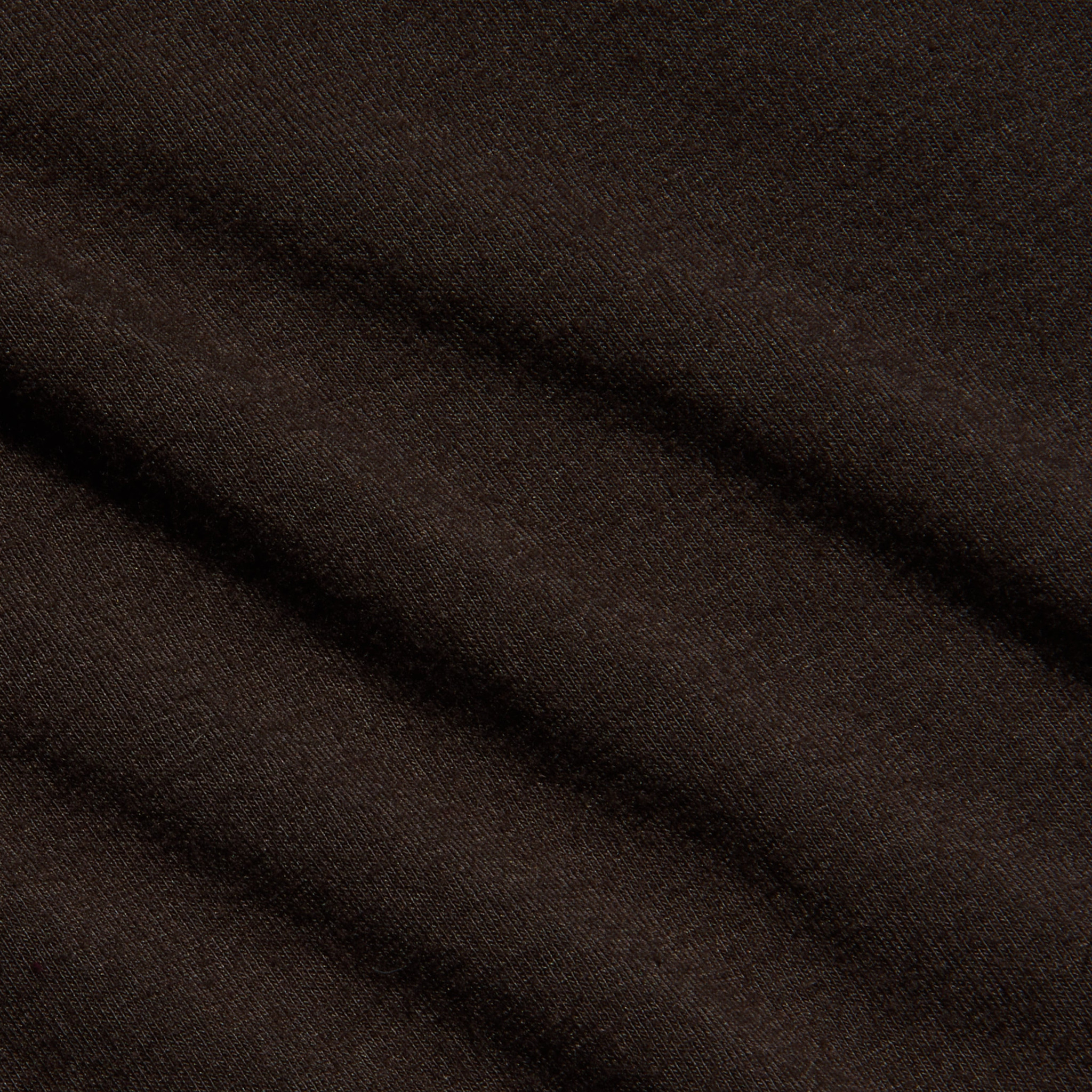 Close-up of the Lani Turtleneck in dark java brown, featuring soft, diagonal folds and a smooth texture. The material appears slightly fuzzy, suggesting warmth and comfort.