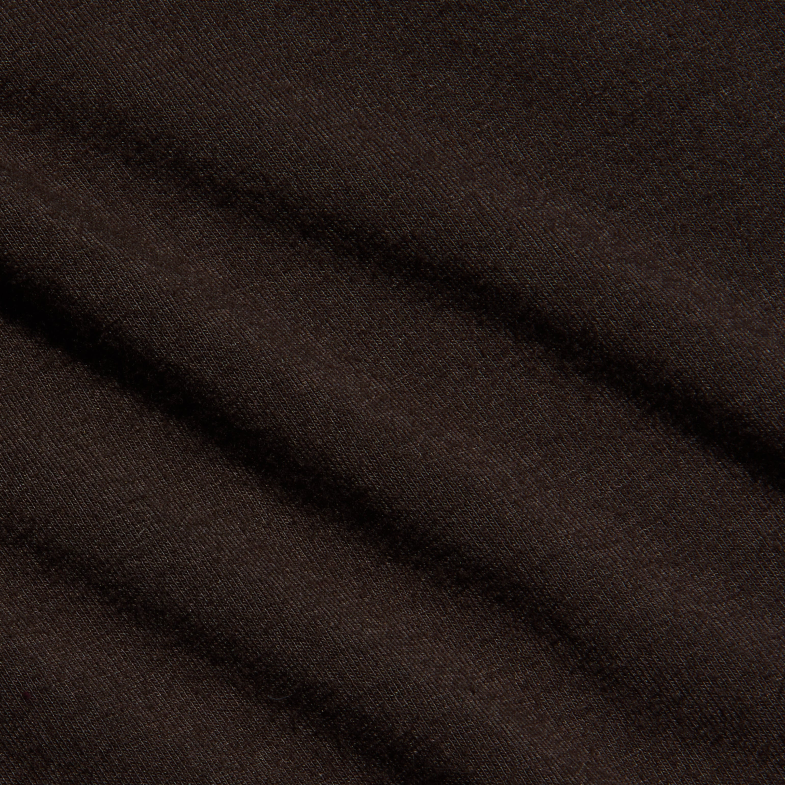Close-up of the Lani Turtleneck in dark java brown, featuring soft, diagonal folds and a smooth texture. The material appears slightly fuzzy, suggesting warmth and comfort.
