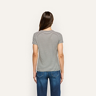 Back view of a person wearing a black and white striped ribbed knit Ressi Fitted Tee and blue jeans.