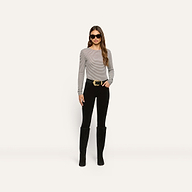 A person wearing a slim-fit, long-sleeve striped Tess Long Sleeve Tee, black pants with a large gold-buckle belt, and tall black boots.