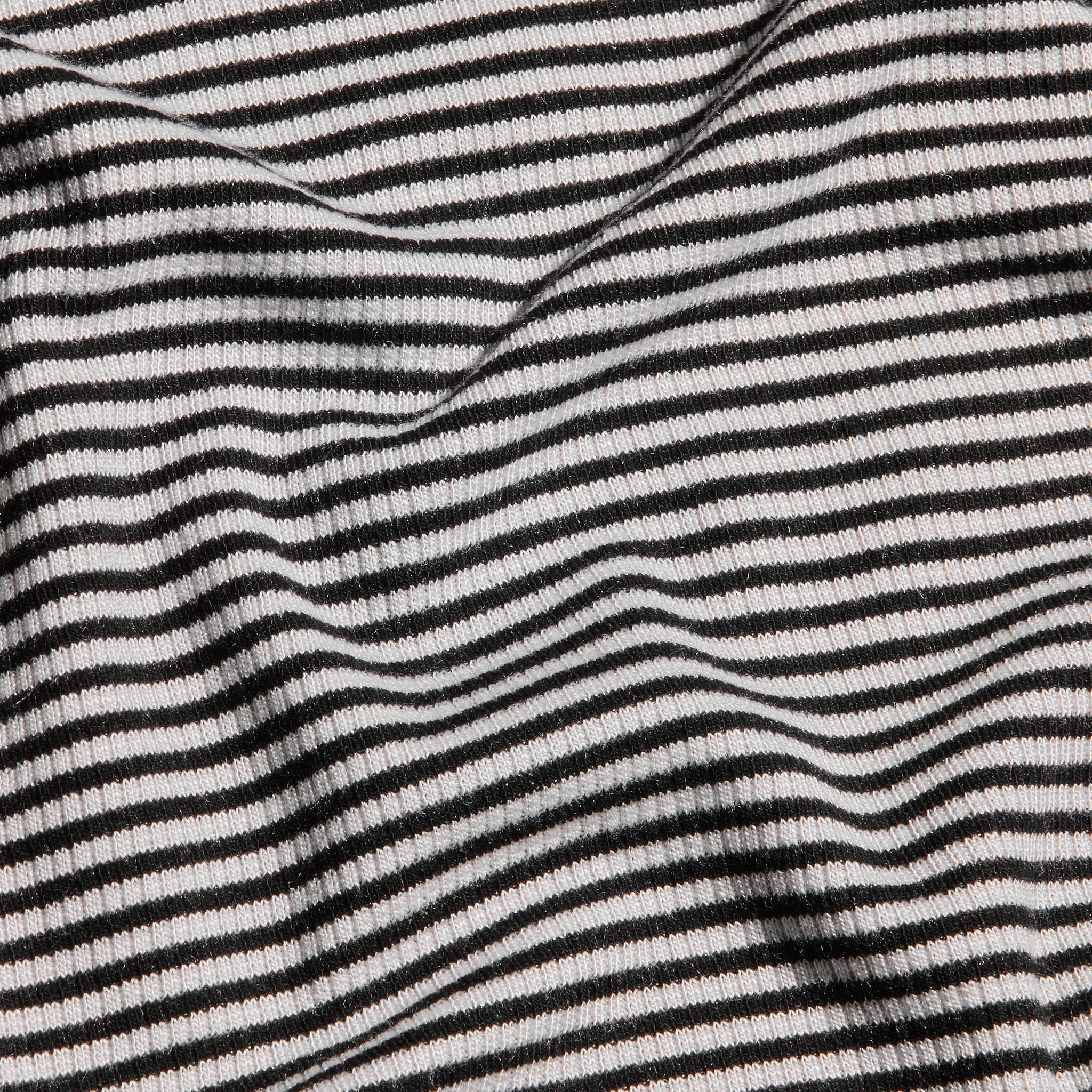 Close-up of the Tess Long Sleeve Tee featuring a black and white striped ribbed knit with gentle folds.