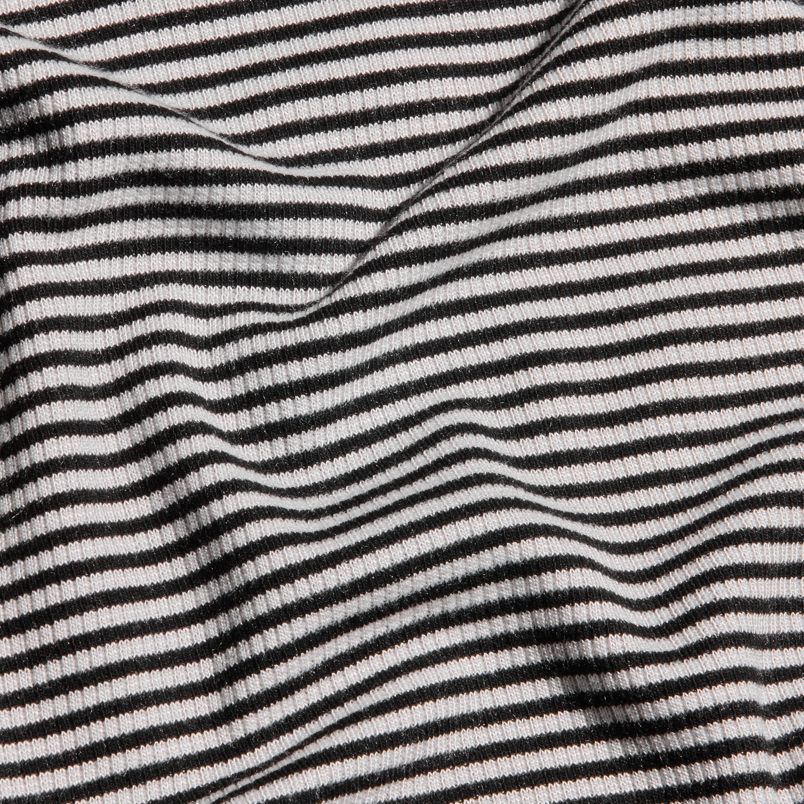 Close-up of the Tess Long Sleeve Tee featuring a black and white striped ribbed knit with gentle folds.