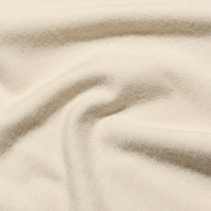 Close-up of a soft, cream-colored Ceci Sleeveless Turtleneck knit top with gentle folds.