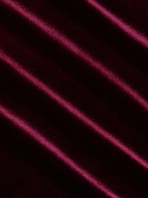 Close-up of deep burgundy velvet with diagonal folds, showcasing the soft, luxurious texture of the Molly Velvet Bodysuit by L'AGENCE.