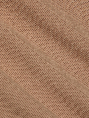Close-up of light brown stretch rib fabric from the Nica Scoopneck Bodysuit by L'AGENCE, featuring diagonal lines and soft shadows that highlight its textured folds—ideal as a cozy base layer.