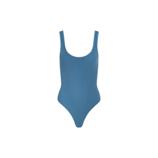 The Nica Scoopneck Bodysuit is a blue, sleeveless one-piece with a sculpted fit, featuring a scoop neckline and high-cut legs, shown against a plain white background.