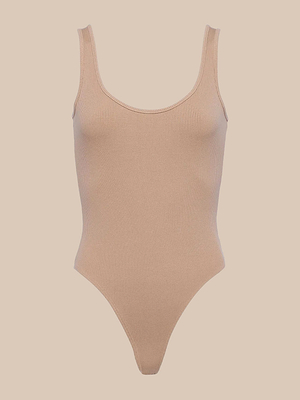 The Nica Scoopneck Bodysuit features a sleeveless, scoop neckline and high-cut legs in stretch rib fabric—ideal as a base layer—shown against a plain beige background.