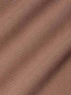 Close-up of the Nica Scoopneck Bodysuits light brown ribbed fabric, featuring horizontal textured lines and subtle shadows that highlight its soft, sculpted fit.