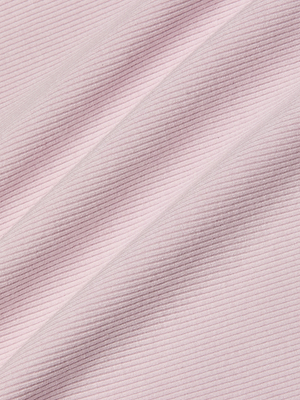 Close-up of light pink ribbed fabric from the Nica Scoopneck Bodysuit, featuring diagonal folds and soft shadows that highlight its sculpted fit and fine, evenly spaced horizontal lines.