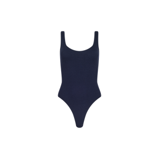 The Nica Scoopneck Bodysuit is a sleeveless, navy blue ribbed bodysuit with a scoop neckline and high-cut legs, offering a sculpted fit and shown against a plain white background.
