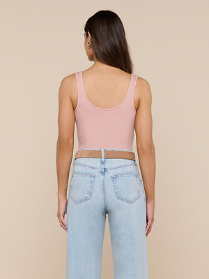 A woman with long brown hair is shown from the back, wearing the Nica Scoopneck Bodysuit in pink and light blue high-waisted jeans, standing against a plain beige background.